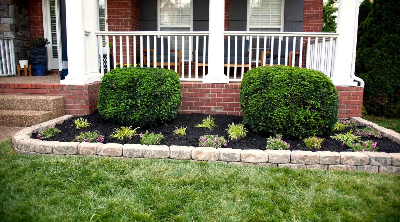 Professional landscape design with shaped shrubs and stone borders in Passaic, NJ