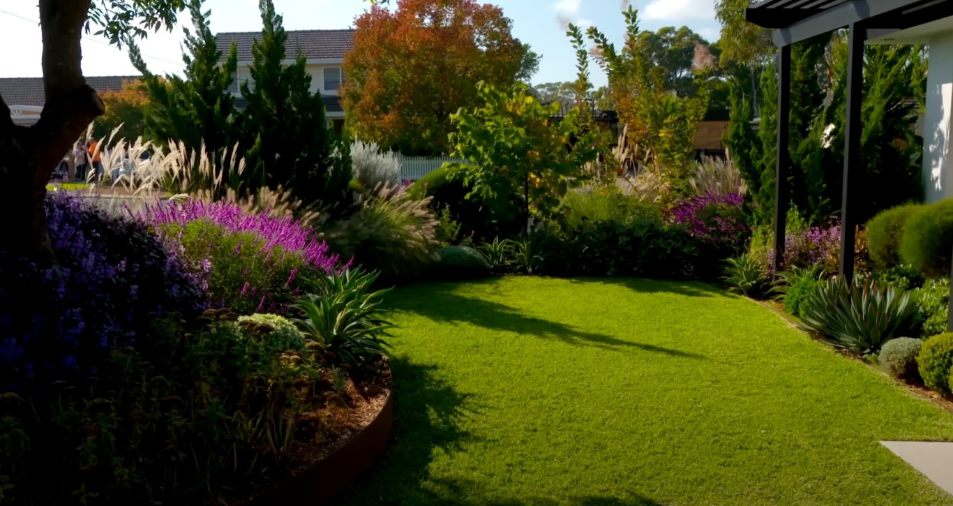 Beautifully maintained green lawn with colorful flower beds in Passaic, NJ